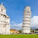 The Leaning Tower of Pisa beside a cathedral with people walking nearby